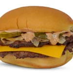 Double-patty cheeseburger with cheddar, pickles, onions, and creamy sauce on a toasted bun.